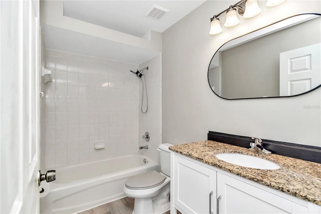 bathroom featuring toilet, vanity, bathtub / shower combination, and wood finished floors