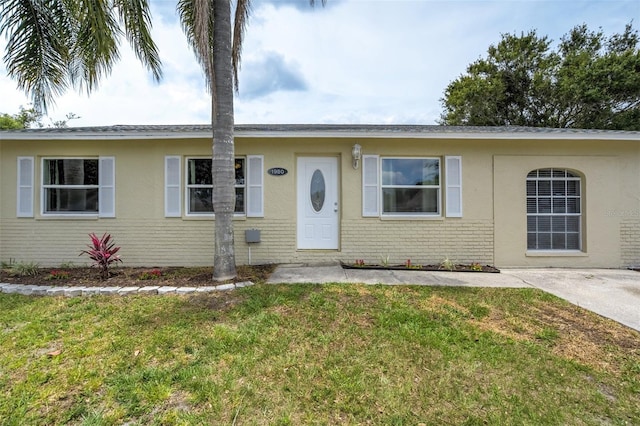 1980 Taylor Lake Cir, Largo, FL 33778 - ranch-style house with brick siding and a front lawn