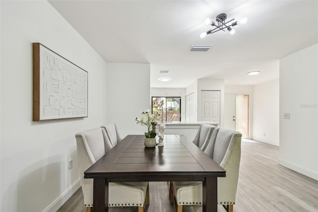 2953 Yucca Ct, Palm Harbor, FL 34684 - dining room featuring baseboards and light wood-style flooring