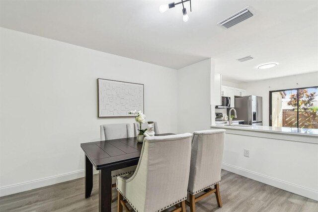 2953 Yucca Ct, Palm Harbor, FL 34684 - dining room with light wood finished floors and baseboards
