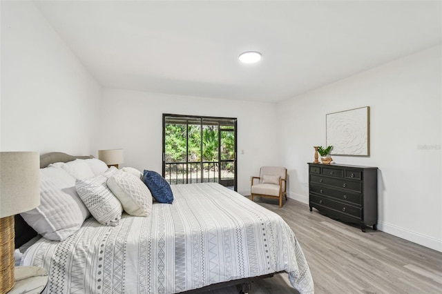 2953 Yucca Ct, Palm Harbor, FL 34684 - bedroom with light wood finished floors, baseboards, and access to exterior