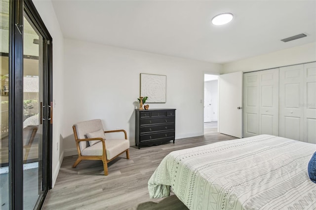 2953 Yucca Ct, Palm Harbor, FL 34684 - bedroom featuring wood finished floors, baseboards, and a closet