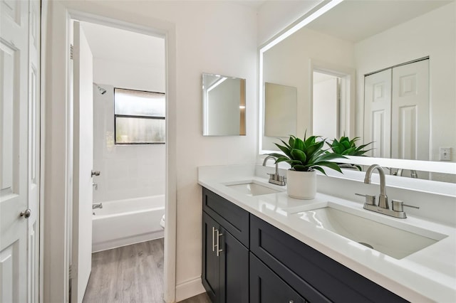 2953 Yucca Ct, Palm Harbor, FL 34684 - bathroom featuring wood finished floors, double vanity, bathtub / shower combination, and toilet