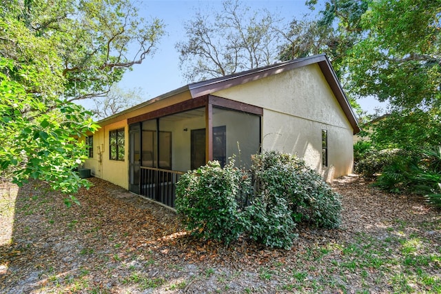 2953 Yucca Ct, Palm Harbor, FL 34684 - view of home's exterior featuring a sunroom and stucco siding