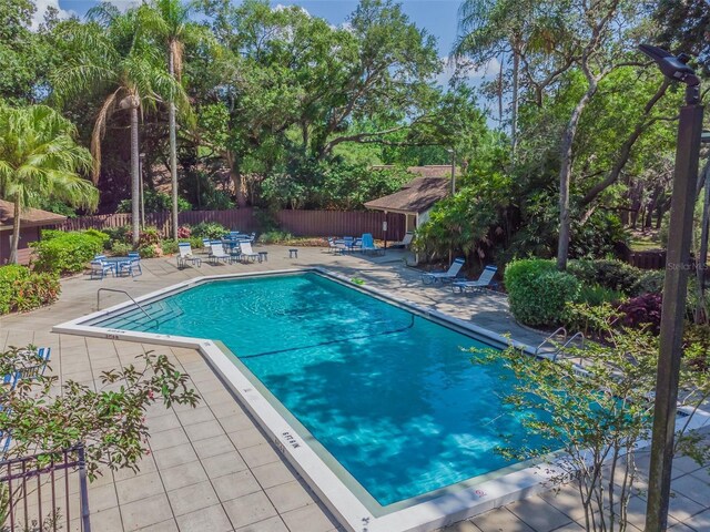2953 Yucca Ct, Palm Harbor, FL 34684 - community pool with a patio area and fence