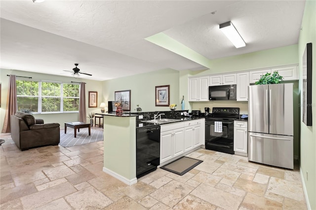 3506 54th Dr W Unit 108, Bradenton, FL 34210 - kitchen with dark countertops, a peninsula, open floor plan, black appliances, and stone tile flooring