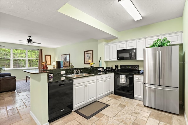 3506 54th Dr W Unit 108, Bradenton, FL 34210 - kitchen featuring black appliances, a peninsula, stone tile flooring, open floor plan, and white cabinetry