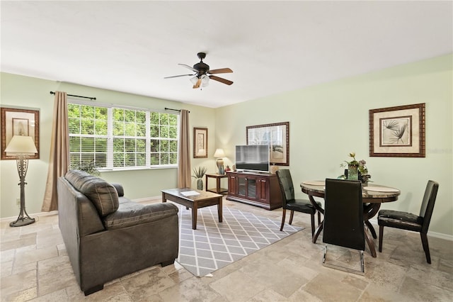 3506 54th Dr W Unit 108, Bradenton, FL 34210 - living room with a ceiling fan, baseboards, and stone tile flooring