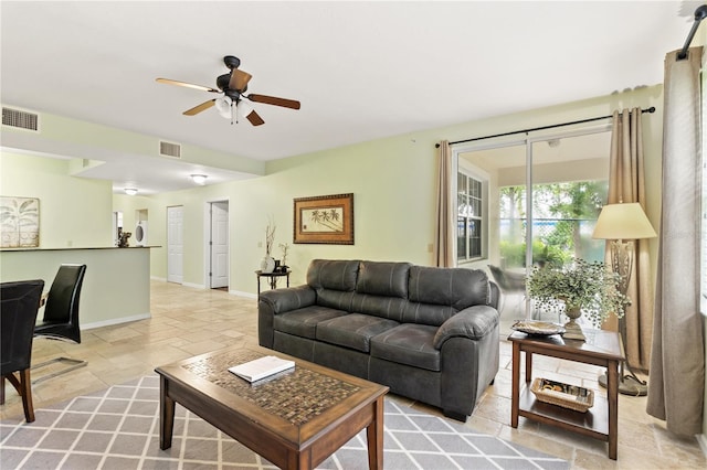 3506 54th Dr W Unit 108, Bradenton, FL 34210 - living area featuring stone tile floors, ceiling fan, visible vents, and baseboards