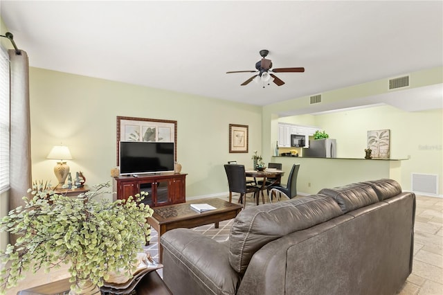 3506 54th Dr W Unit 108, Bradenton, FL 34210 - living area with visible vents, a ceiling fan, and stone tile flooring