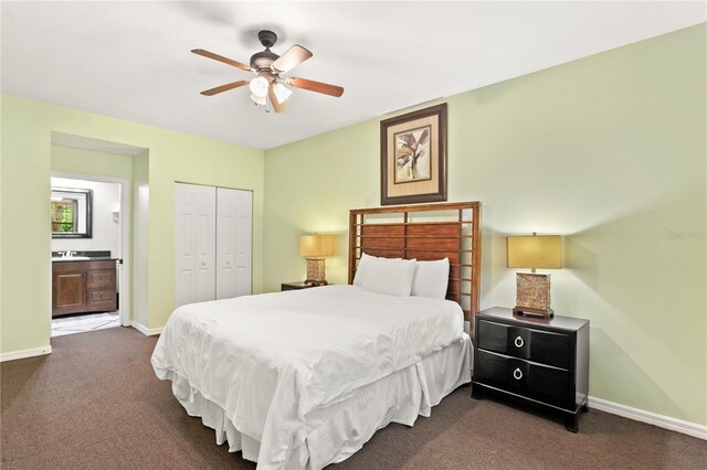 3506 54th Dr W Unit 108, Bradenton, FL 34210 - bedroom featuring ceiling fan, baseboards, a closet, dark colored carpet, and ensuite bath