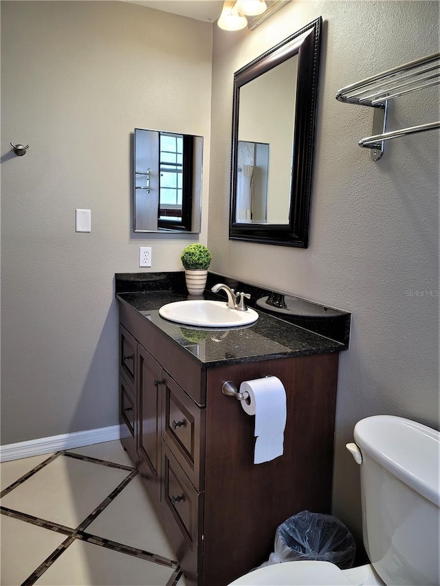 3506 54th Dr W Unit 108, Bradenton, FL 34210 - bathroom featuring vanity, baseboards, and toilet
