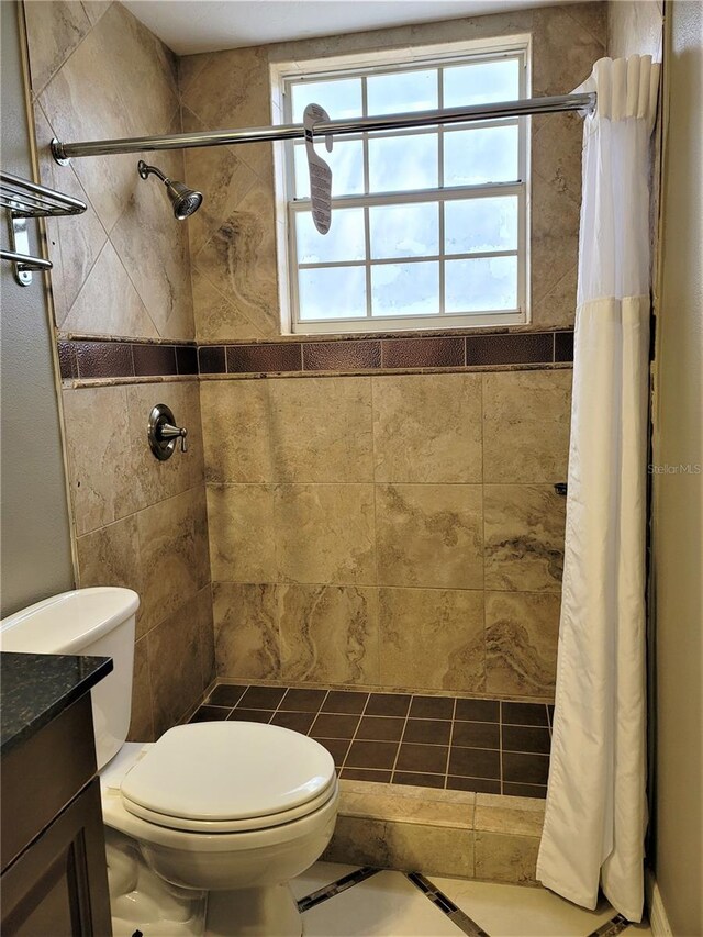 3506 54th Dr W Unit 108, Bradenton, FL 34210 - bathroom with toilet, a tile shower, a wealth of natural light, and vanity