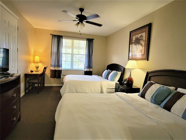 3506 54th Dr W Unit 108, Bradenton, FL 34210 - bedroom with dark colored carpet, a ceiling fan, and baseboards