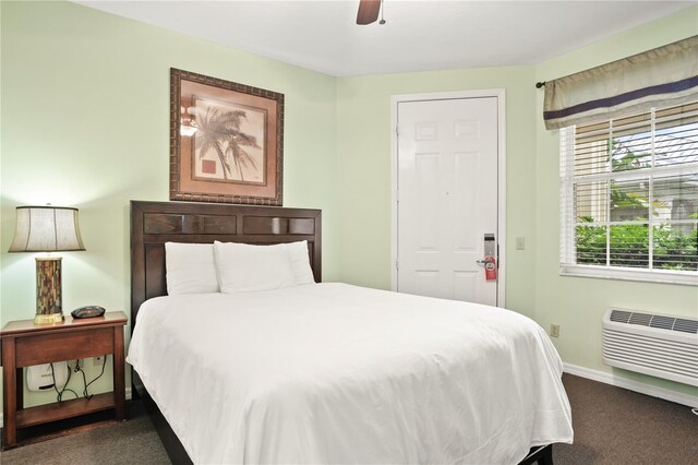 3506 54th Dr W Unit 108, Bradenton, FL 34210 - carpeted bedroom with baseboards, a wall unit AC, and a ceiling fan