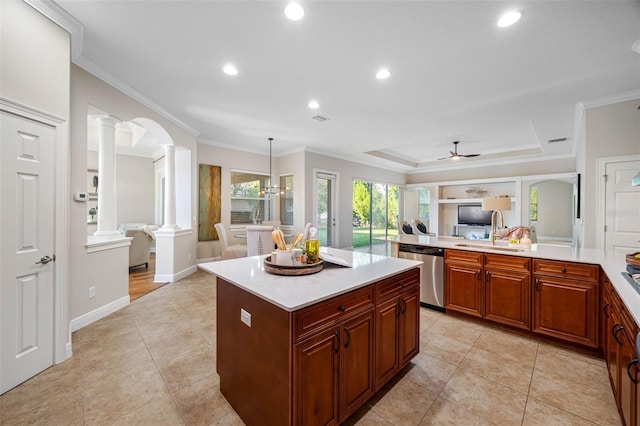 kitchen with light countertops, ornate columns, a sink, open floor plan, and dishwasher