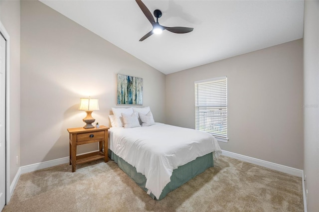 bedroom featuring baseboards, light carpet, a ceiling fan, and vaulted ceiling