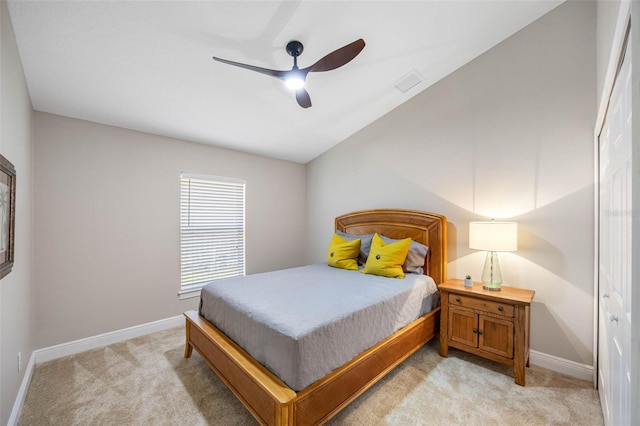 bedroom with baseboards, a ceiling fan, and light colored carpet