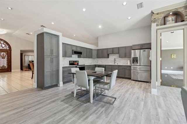 3238 Cullendale Dr, Tampa, FL 33618 - dining space with visible vents, baseboards, and vaulted ceiling