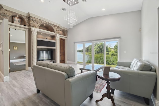3238 Cullendale Dr, Tampa, FL 33618 - living area with visible vents, wood finished floors, high vaulted ceiling, baseboards, and a chandelier