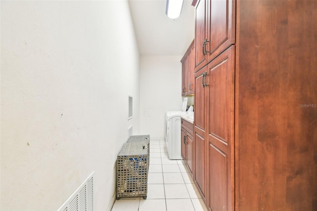 3238 Cullendale Dr, Tampa, FL 33618 - clothes washing area with light tile patterned floors, washer and clothes dryer, cabinet space, and visible vents