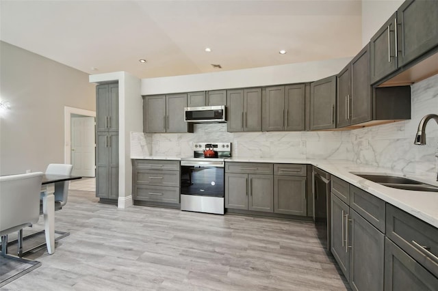 3238 Cullendale Dr, Tampa, FL 33618 - kitchen with light wood finished floors, appliances with stainless steel finishes, tasteful backsplash, and a sink