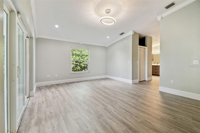 3238 Cullendale Dr, Tampa, FL 33618 - spare room featuring visible vents, ornamental molding, light wood-style flooring, and baseboards