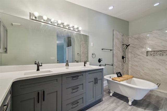3238 Cullendale Dr, Tampa, FL 33618 - bathroom featuring a sink, a soaking tub, wood finished floors, double vanity, and tiled shower