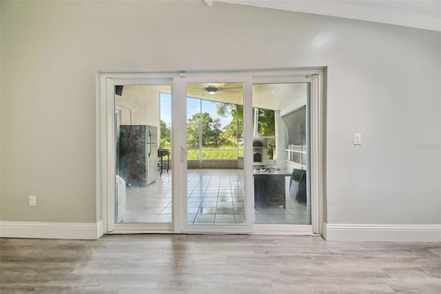 3238 Cullendale Dr, Tampa, FL 33618 - doorway to outside with baseboards, ceiling fan, vaulted ceiling, and wood finished floors