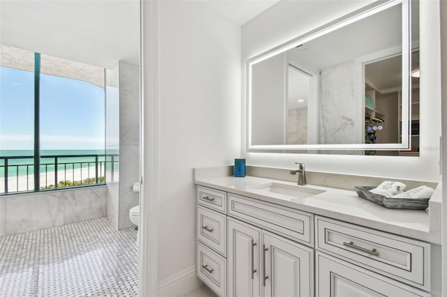 bathroom with vanity, a water view, and toilet