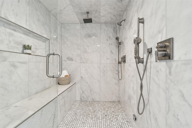 bathroom featuring a marble finish shower