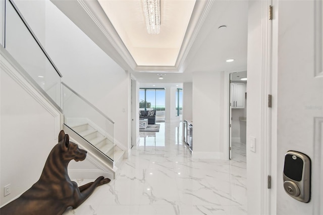 entrance foyer featuring marble finish floor, recessed lighting, baseboards, a tray ceiling, and stairway