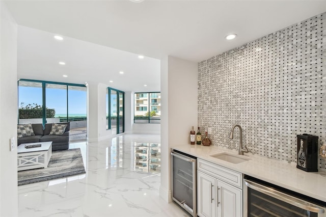 bar with a sink, wet bar, recessed lighting, and beverage cooler