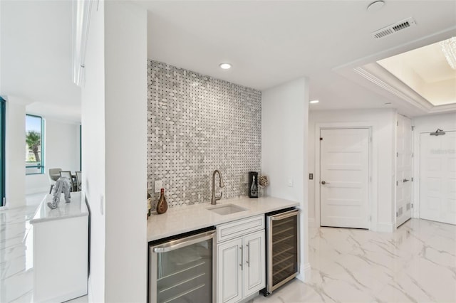 bar featuring beverage cooler, a sink, wet bar, and visible vents