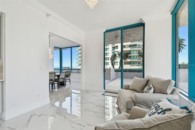 living area featuring baseboards, ornamental molding, marble finish floor, and a chandelier