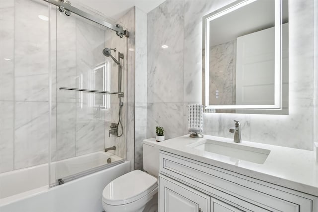 full bath with enclosed tub / shower combo, toilet, tile walls, and vanity