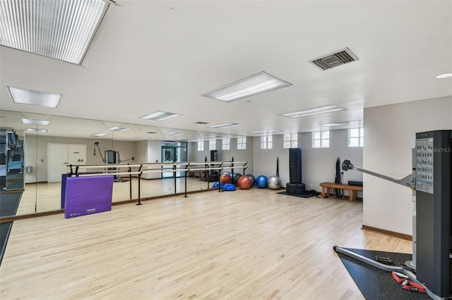 workout area featuring wood finished floors and visible vents