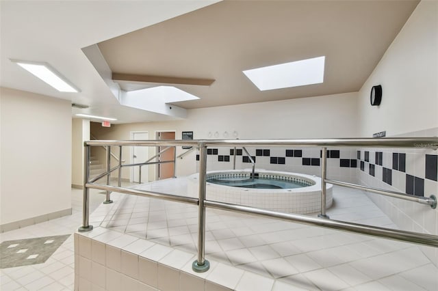 washroom featuring tile patterned floors and a skylight