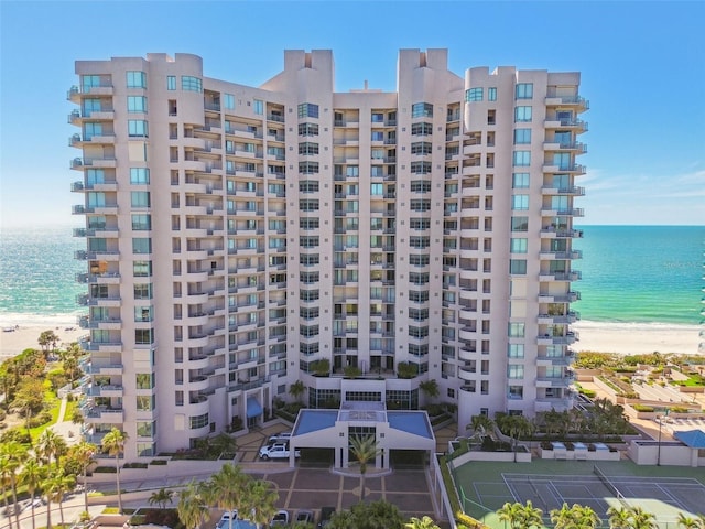 view of building exterior with a view of the beach and a water view