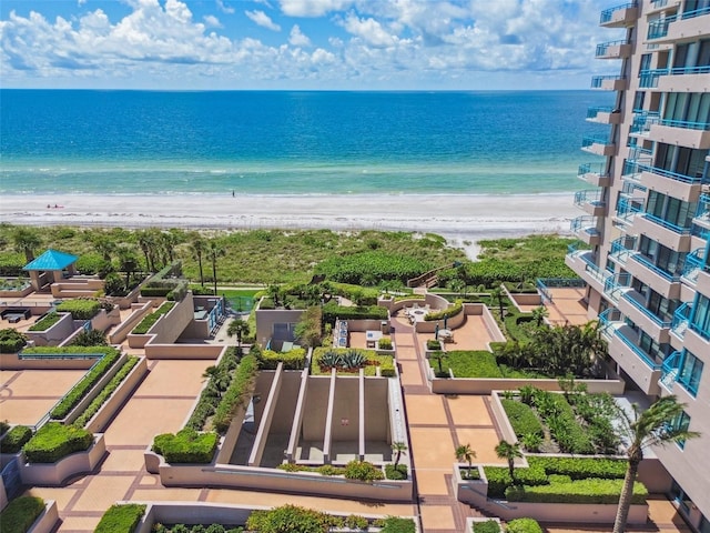 bird's eye view featuring a water view and a beach view
