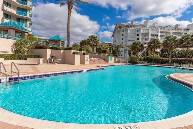 community pool with a patio area