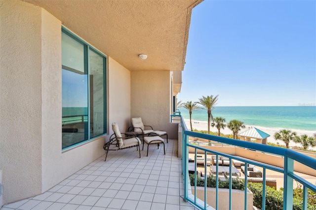 balcony with a beach view and a water view