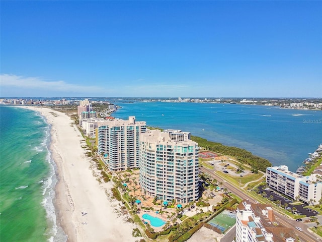 birds eye view of property featuring a beach view and a water view