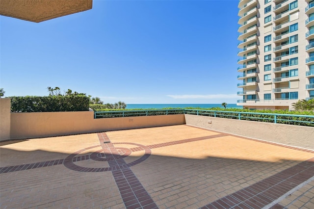 view of patio with a water view and a balcony