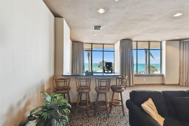 interior space featuring recessed lighting, a textured ceiling, and visible vents