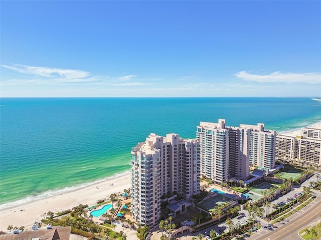 birds eye view of property featuring a beach view and a water view