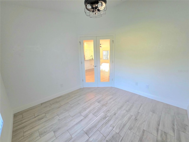 11240 Marvelwood, Brooksville, FL 34614 - spare room featuring baseboards, french doors, and wood tiled floor