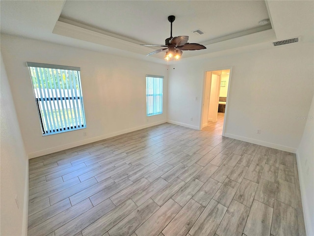 11240 Marvelwood, Brooksville, FL 34614 - unfurnished room with a ceiling fan, a raised ceiling, light wood-type flooring, and visible vents