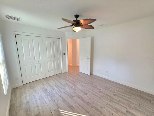 11240 Marvelwood, Brooksville, FL 34614 - unfurnished bedroom featuring a closet, light wood-style floors, visible vents, and baseboards