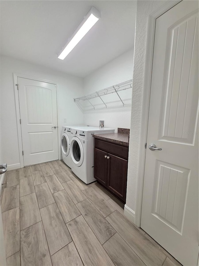 11240 Marvelwood, Brooksville, FL 34614 - clothes washing area featuring cabinet space, separate washer and dryer, and wood tiled floor
